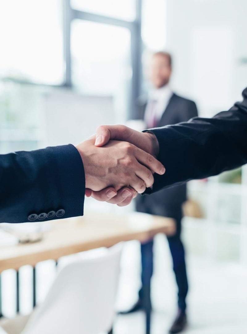 close-up partial view of businessmen shaking hands